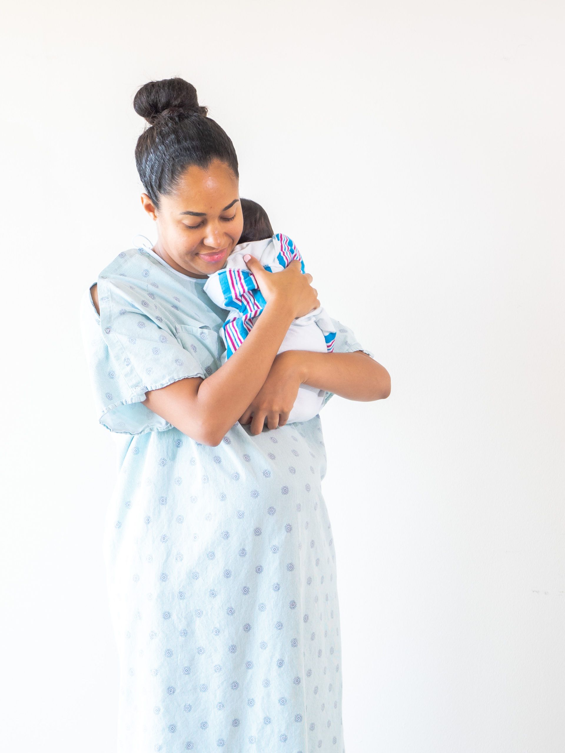 mom in hospital robe with infant