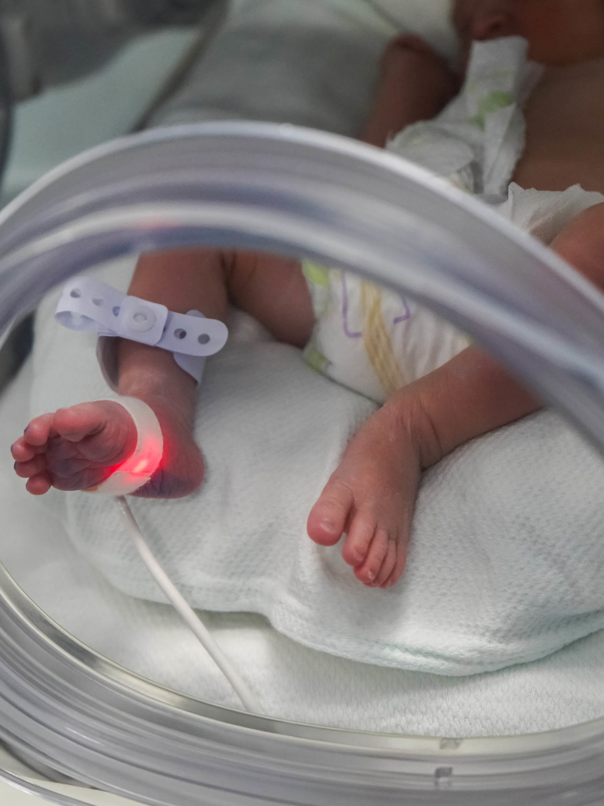 New born baby at the hospital in neonatal care incubator
