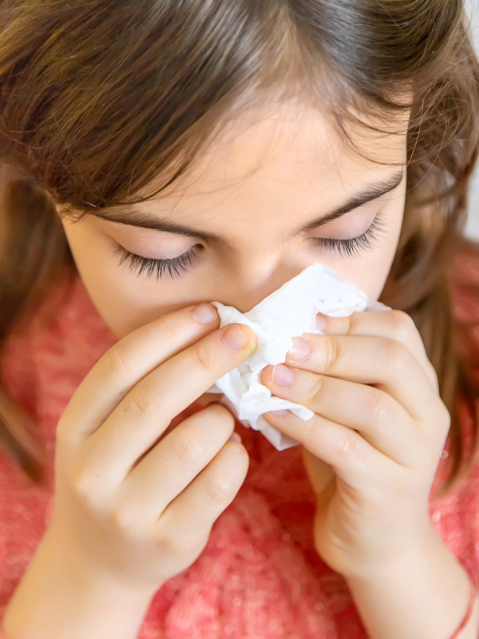 Child with severe allergies blows nose